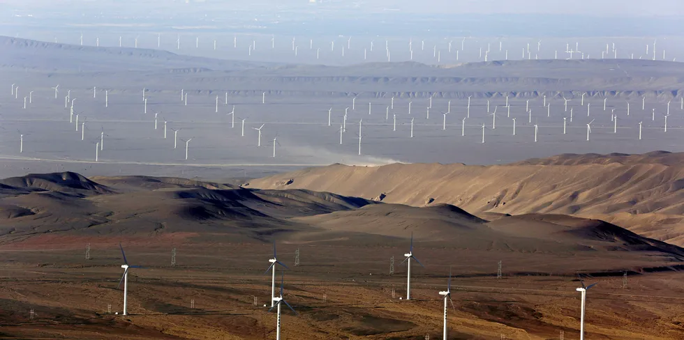 Hundreds of wind turbines sit in the Turfan Depression in China's northwestern Xinjiang on July 18, 2016. / AFP / PATRICK BAZ (Photo credit should read PATRICK BAZ/AFP/Getty Images) China 403GW wind. China wind turbines.