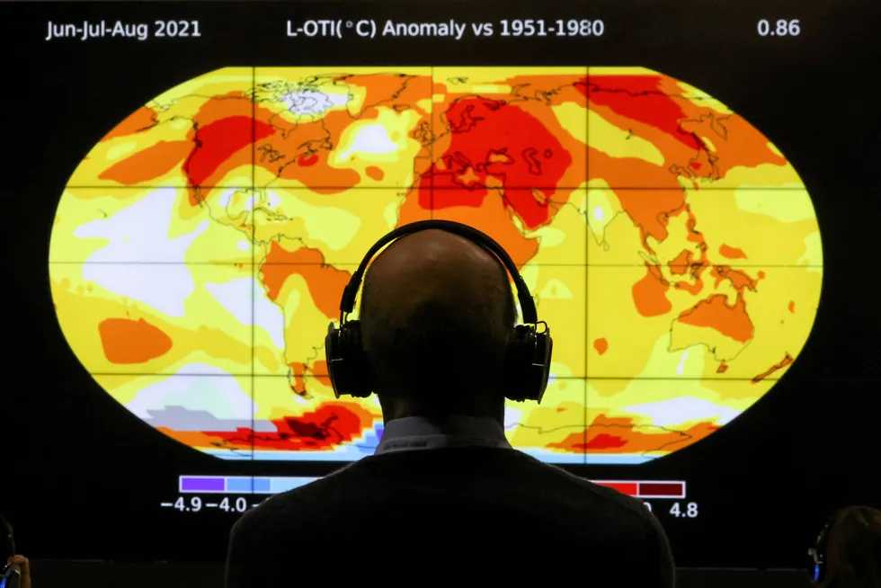 Burning issue: a delegate looks at a screen during COP26 in Glasgow