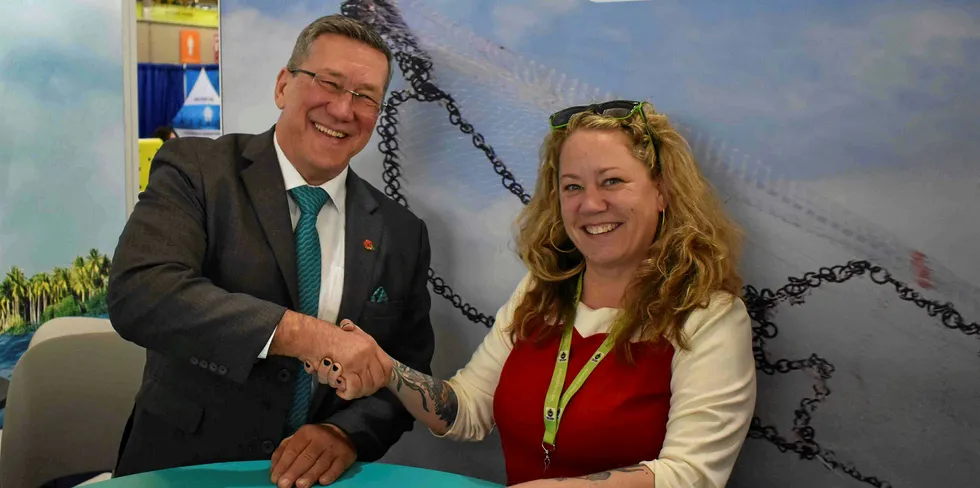 Chris Ninnes and Fairtrade's Julie Kuchepatov signing an MOU at the ASC stand at Seafood Expo North America in Boston.