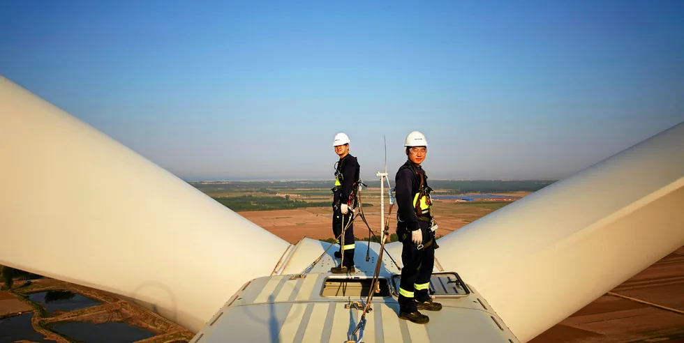 Workers on top of a Vestas turbine in China