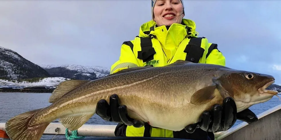 Employee holds one of Norcod's farmed cod.