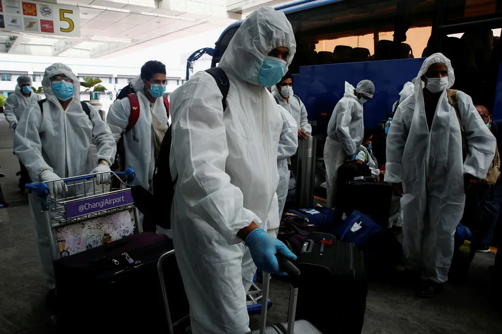 The new normal: seafarers arrive at Singapore's Changi Airport to board a flight back home to India during a crew change amid the coronavirus outbreak