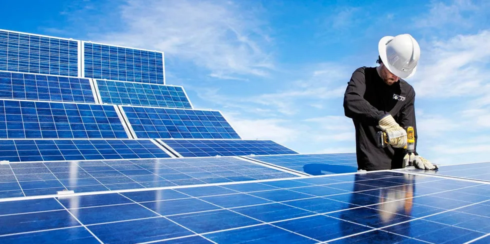Electrician works on PV array at the Northern Alberta Institute of Technology