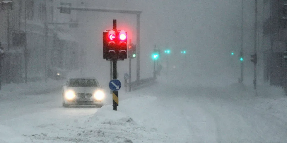 Traffic moves on snow covered roads in Kristiansand, Norway.