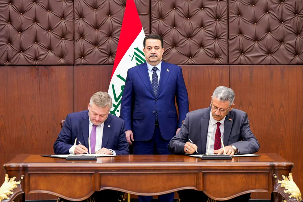 Iraqi Prime Minister, Mohammed Shia' Al Sudani, looks on as BP chief executive, Murray Auchincloss, (left) and Iraq's Minister of Oil, Hayan Abdel-Ghani, (right) on 1 August 2024 sign a memorandum of understanding to rehabilitate fields in Kirkuk.