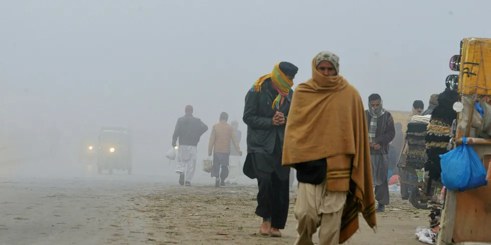 Commuters amid fog and air pollution in Islamabad, Pakistan