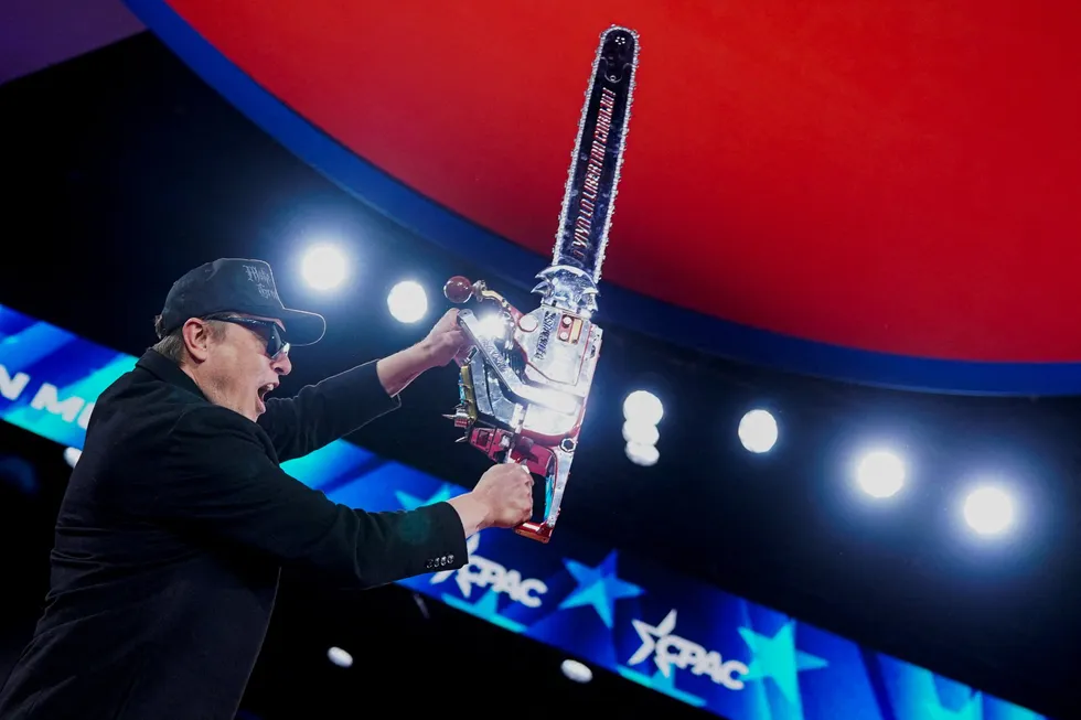 Elon Musk wields a chainsaw during a recent event Maryland, US. The technology mogul has been leading US President Donald Trump's federal cost reduction drive.