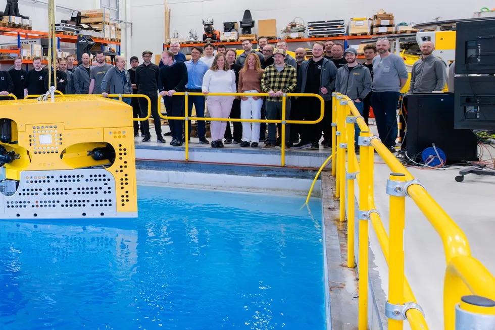 Workers for Kystdesign observe one of the company's remotely operated vehicle (ROV) systems at a company facility.