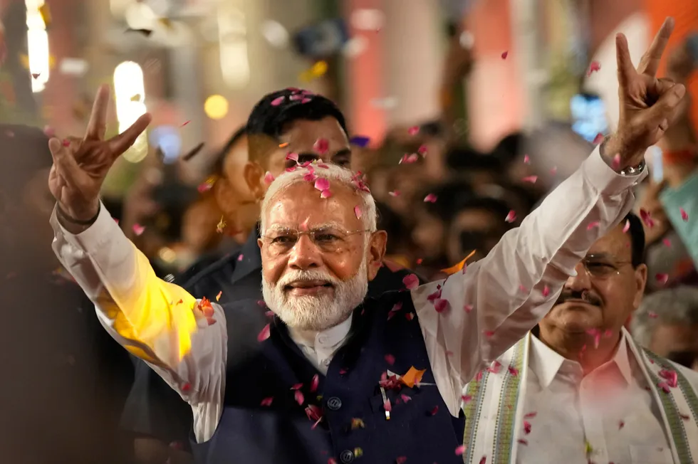 Prime Minister Narendra Modi greets supporters as he arrives at Bharatiya Janata Party (BJP) headquarters in New Delhi.
