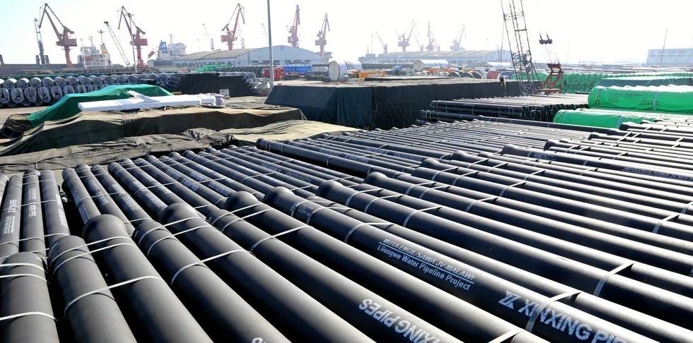 Cast steel pipes are discharged at the port waiting for shipment in Lianyungang, east China's Jiangsu Province.