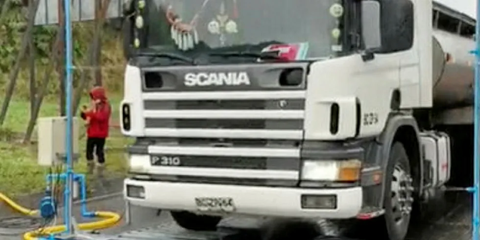 A truck arriving on Chiloe Island is sprayed with disinfectant.