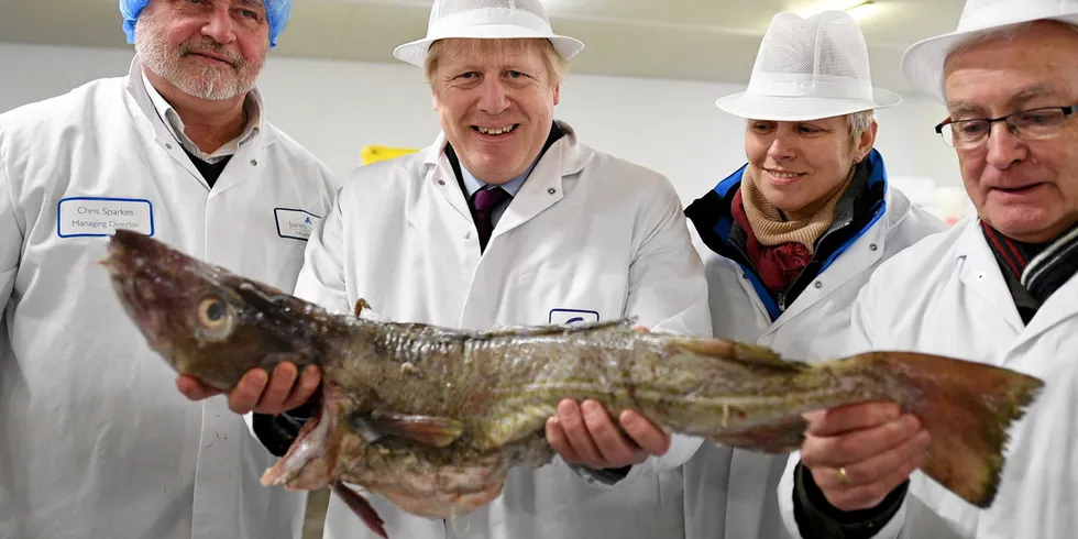 UK Prime Minister Boris Johnson pictured at Grimsby Fish Market during the optimistic days of 2019. UK seafood exporters are hurting following his Brexit trade deal, with some ceasing to trade completely.