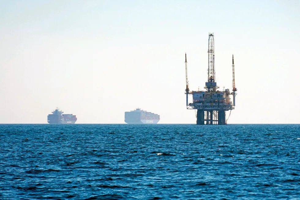 In the queue: cargo vessels anchored offshore near an oil platform before heading into the Los Angeles-Long Beach port in the US