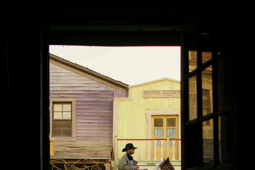 Exploration opening: a cowboy actor rides his horse through a western movie set in Spain, where Steve McQueen charged the barren hills in The Magnificent Seven.