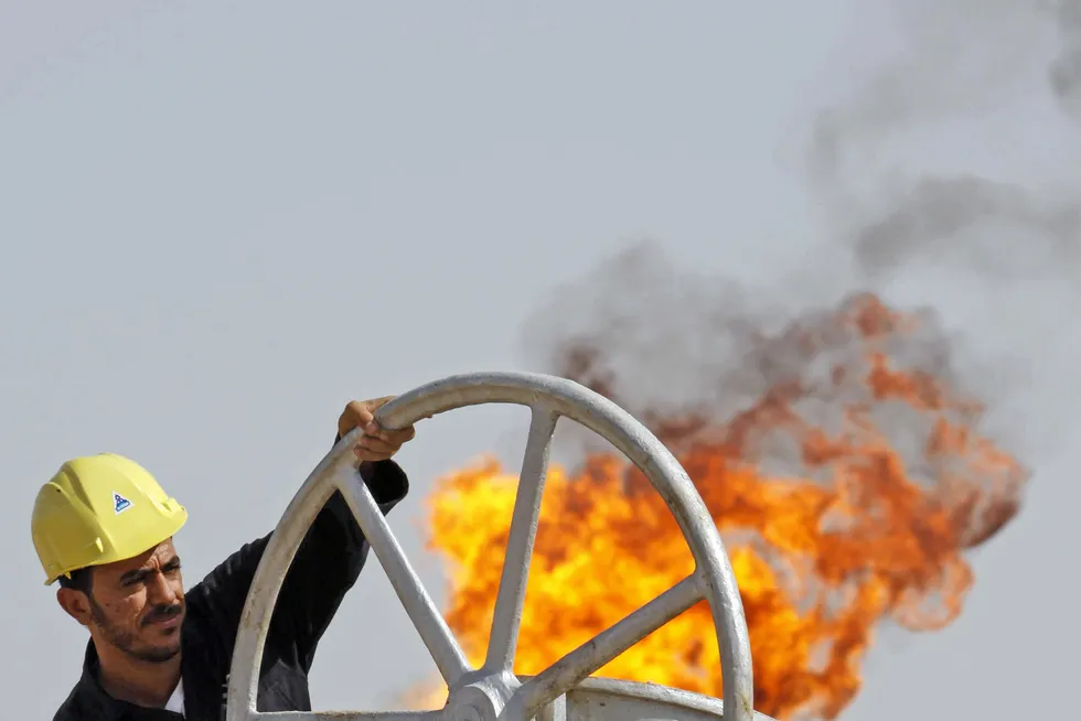 An Iraqi worker operates valves at the Nahran Omar oil refinery near the city of Basra, Iraq.