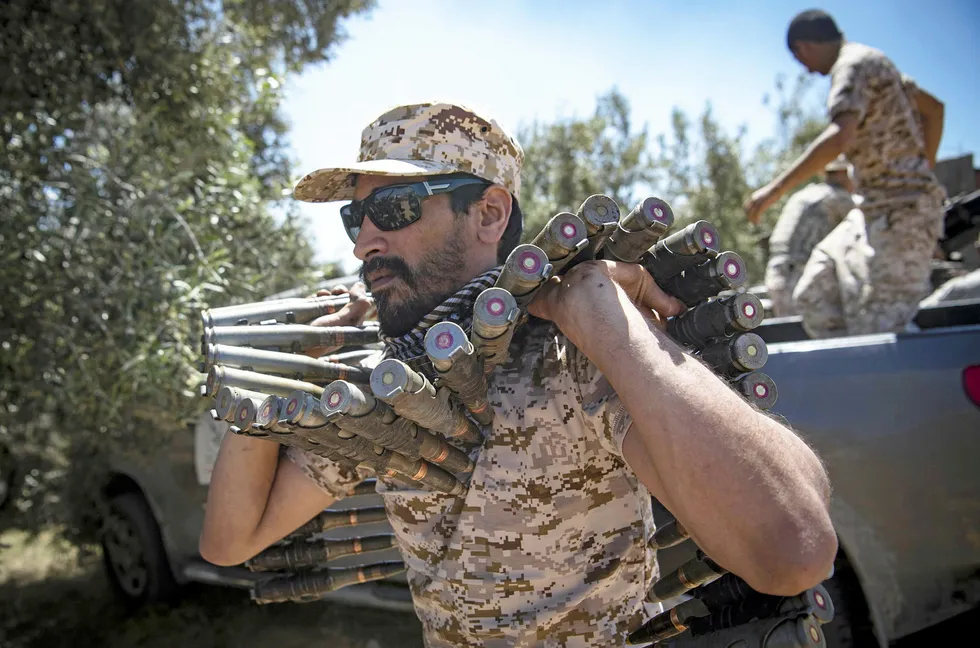 Libya Fight: a fighter loyal to the internationally-recognised Government of National Accord carries a bullet belt