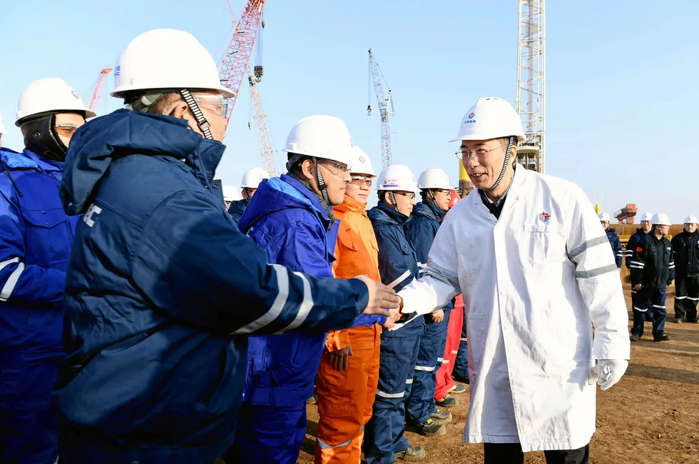CNOOC Ltd chairman, Wang Dongjin, (right in white).