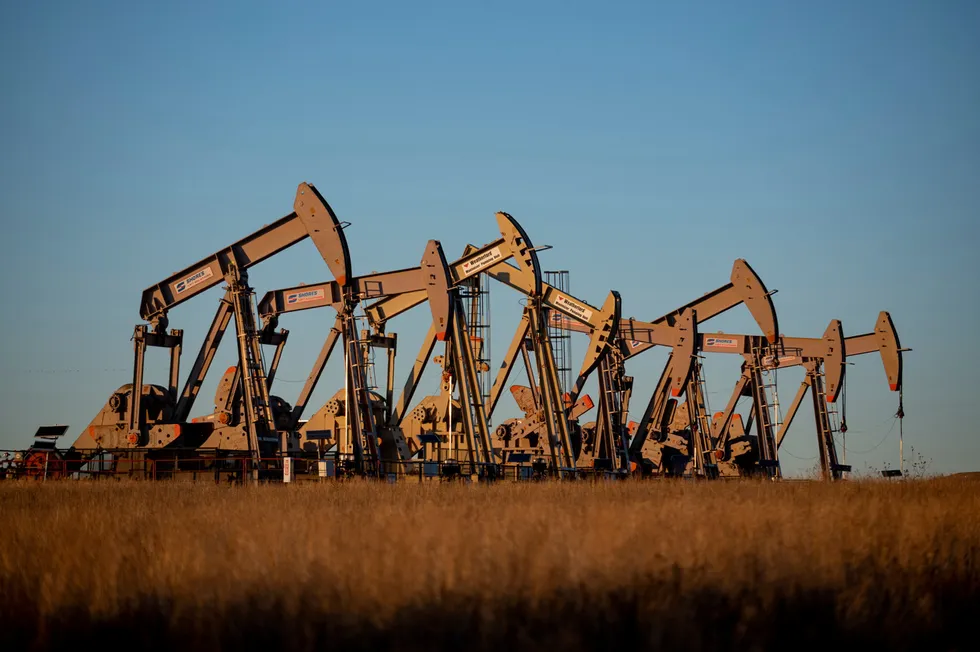 This 2020 file photo shows oil derricks owned by Extraction Oil & Gas pump near the intersection of Colorado Highway 392 and Weld County Road 25 near Windsor in Weld County, Colorado.