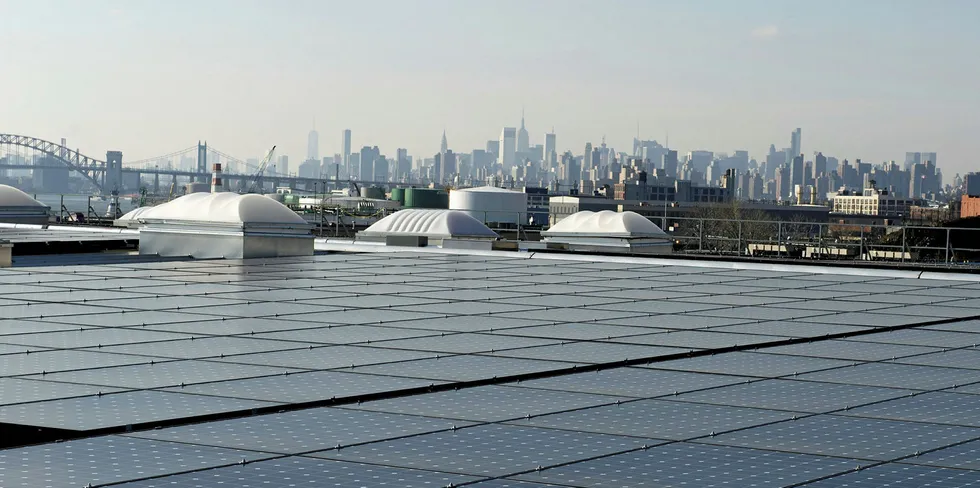A warehouse solar rooftop in The Bronx, with Manhattan in the distance.