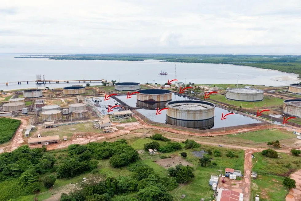 Major oil leak: an oil spill from a Perenco-operated storage tank at Cap Lopez has so far been mostly contained by retainment berms - red arrows indicate extent of spill