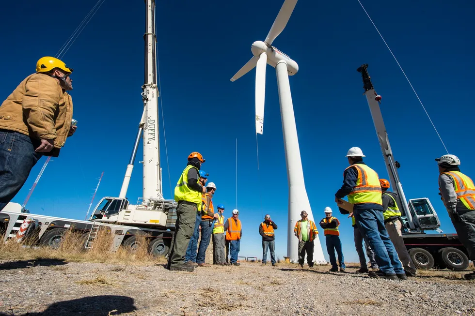 NREL engineers and technicians lower the rotor and blades off of the Cart 3 research turbine at NREL's National Wind Technology Center.
