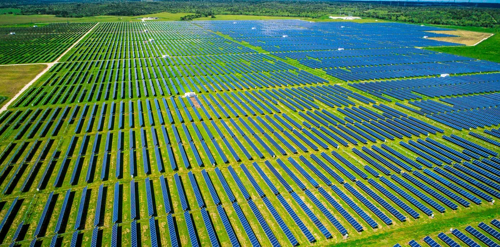 Aerial drone view above thousands of PV panels making up a Texas solar plant