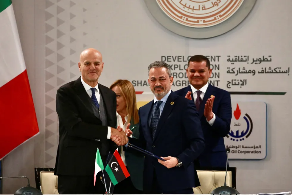 Eni chief executive Officer Claudio Descalzi (left), and Farhat Bengdara, head of Libyan state oil company, shjake hands in Tripoli, Libya in 2023.