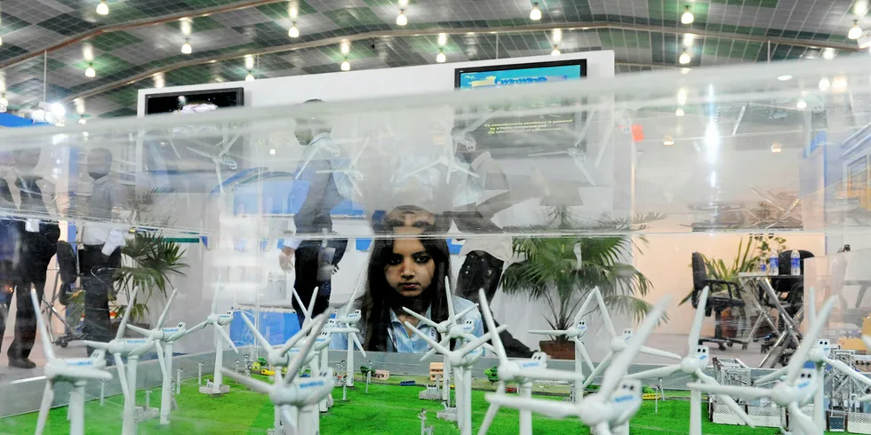 An Indian girl takes a look at scale model replicas of wind turbines.