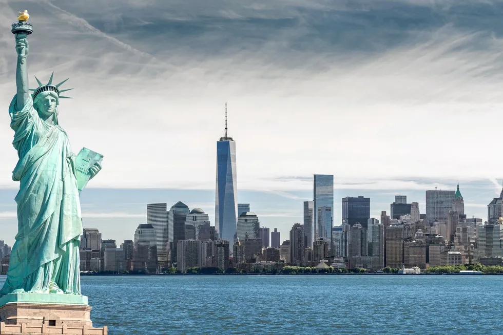 The Statue of Liberty with One World Trade Center background in New York City