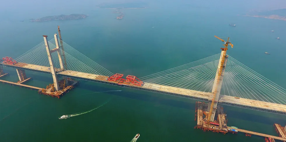 Aerial view of the last steel girder being lifted to complete the main span of the Fuzhou-Pingtan cross-strait highway-railway bridge under construction in Pingtan in southeast China's Fujian province.