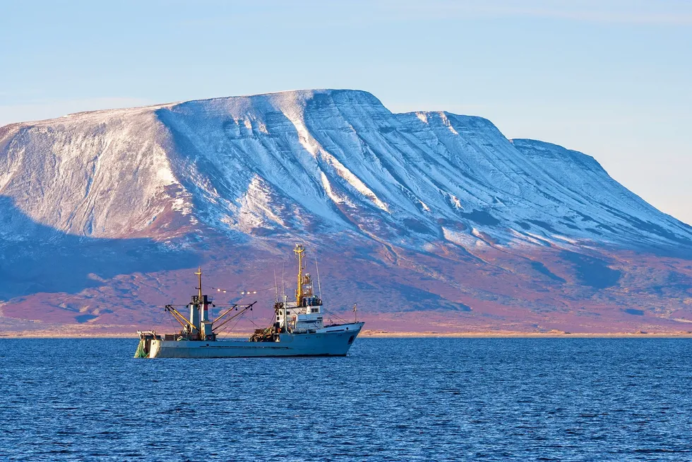A fishing vessel in the Bering Sea, with the far eastern Russian region of Chukotka in the background.