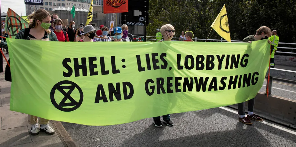 Campaigners protest at Shell 'greenwashing'. The company hit back at an SEC complaint.