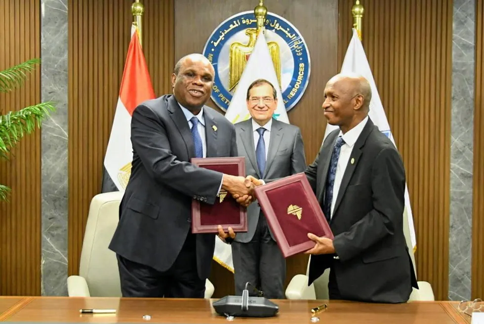 Tarek El Molla, Egypt's minister of petroleum, looks on as Benedict Oramah, chairman of Afreximbank (left) exchanges establishment agreement documents for the Africa Energy Bank with Omar Farouk Ibrahim, secretary general of APPO.