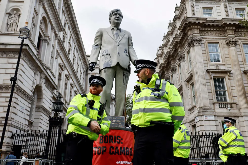 Protest: police officers stand next to an oil-splattered statue of UK Prime Minister Boris Johnson following anti-Cambo protests by Greenpeace activists last year