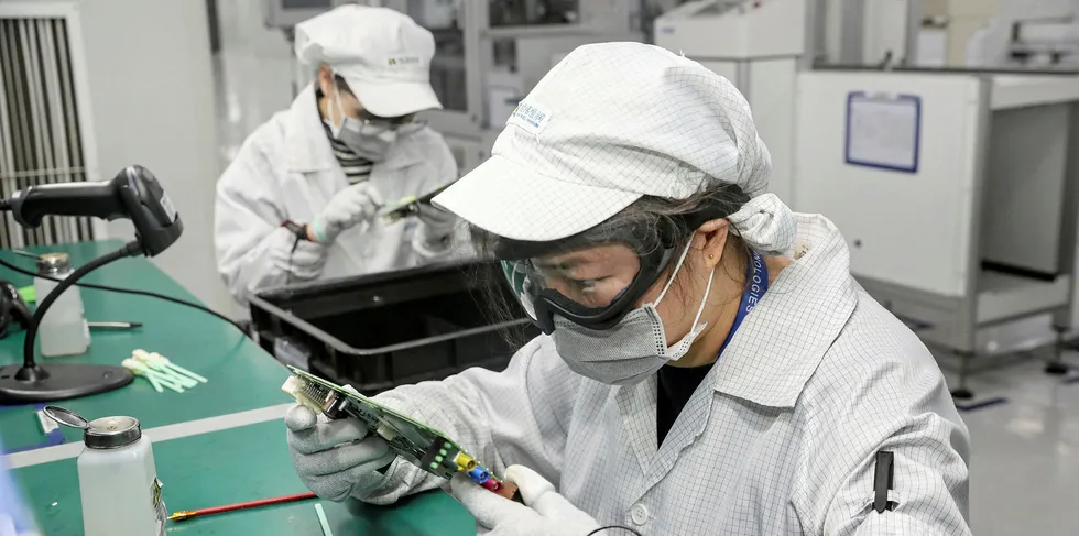A Chinese employee works at a factory in Nantong in China's eastern Jiangsu province on February 10, 2020.