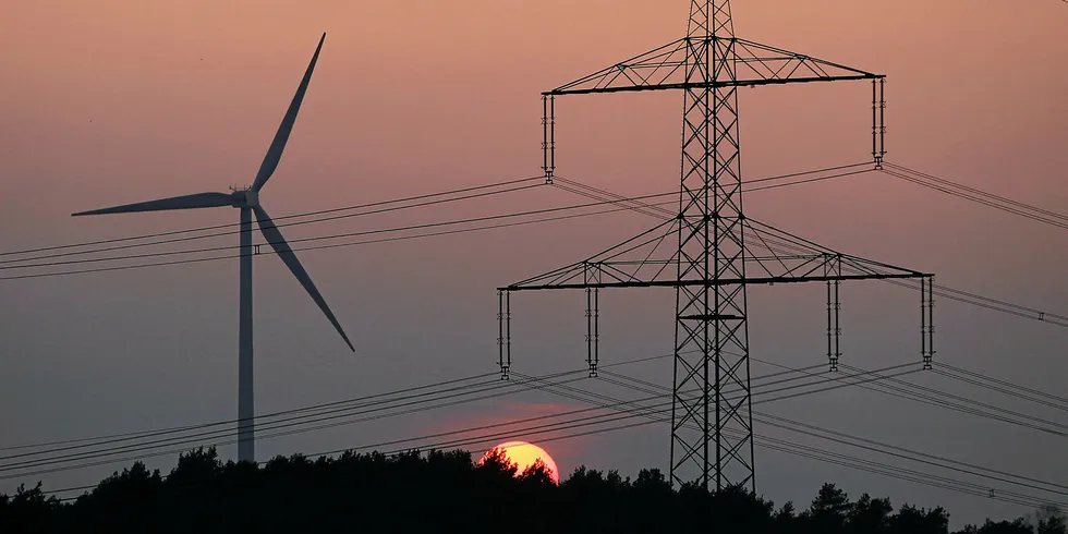 high-voltage transmission cables near a wind turbine in Germany