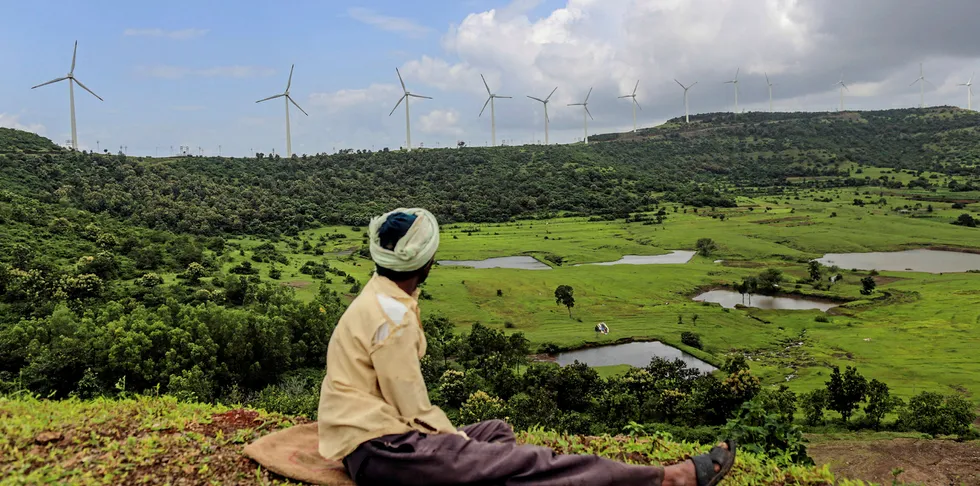 Shepherd near wind turbines at Amberi wind farms in Rewalkawadi, Maharashtra, India