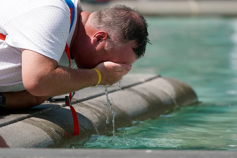 Scorcher: A man refreshes his face at a fountain in Trafalgar Square in central London Tuesday