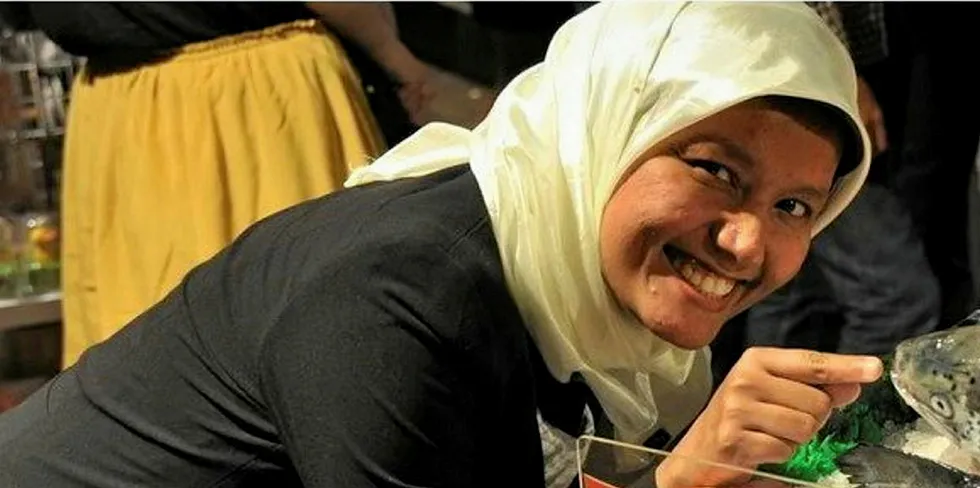 An Indonesian woman getting acquainted with salmon. Is pollock next on the menu?