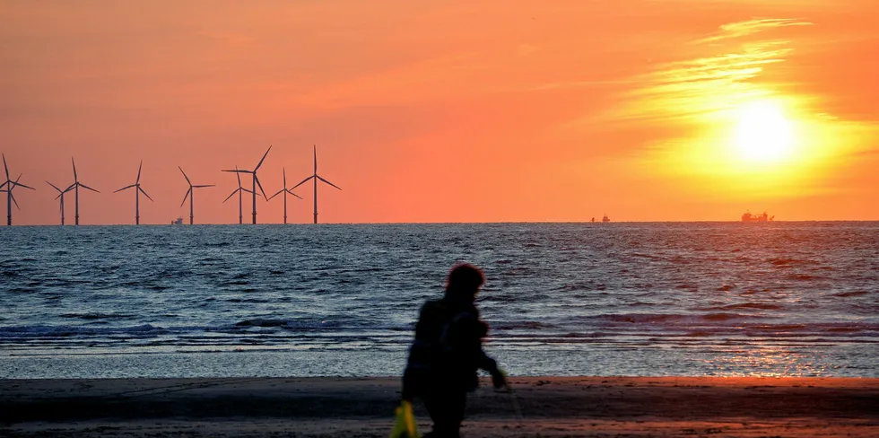 The sun sets over the Burbo Bank wind farm in the Irish Sea viewed from New Brighton, north west England.