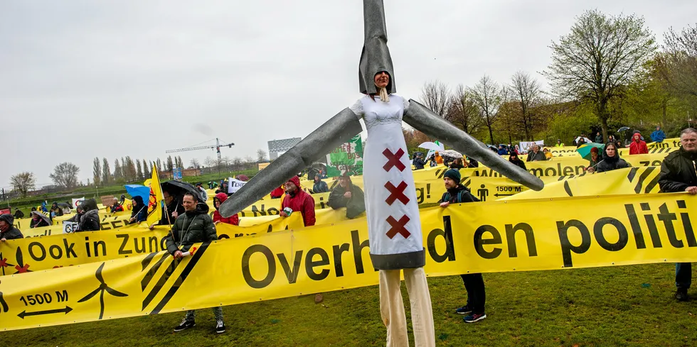 A woman dressed as a wind turbine during a protest in the Netherlands against wind turbines near homes and in nature reserves.