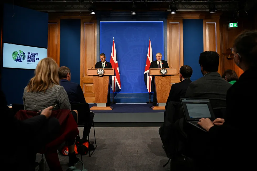 Post Glasgow: COP26 President Alok Sharma (back centre) and UK Prime Minister Boris Johnson (back right) at a press conference at 10 Downing Street on 14 November