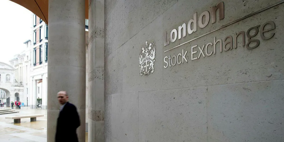 A man walks past the London Stock Exchange in central London
