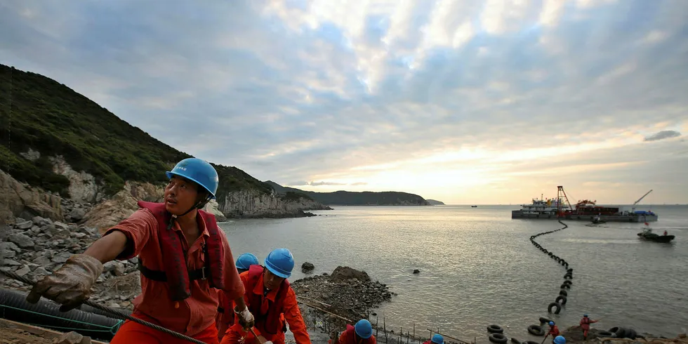 Workers labouring on the transmission cable to the 250MW Guodian Zhoushan Putuo No. 6 offshore wind farm in Zhejiang province