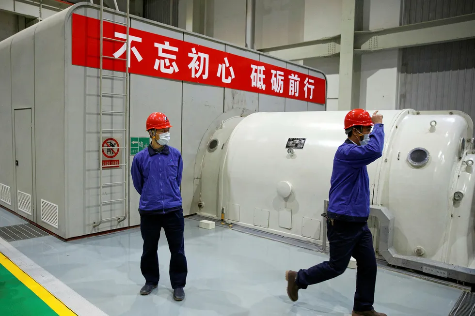 Caution: workers wear face masks during a government-organised tour of a Beijing power plant as the country is hit by a coronavirus outbreak
