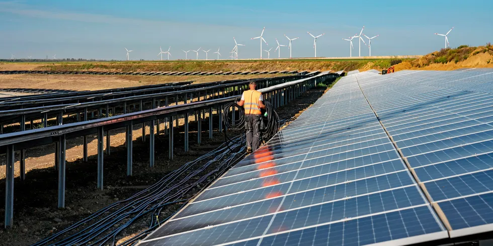RWE Indeland solar array adjacent to lignite mine, with wind farm in background.