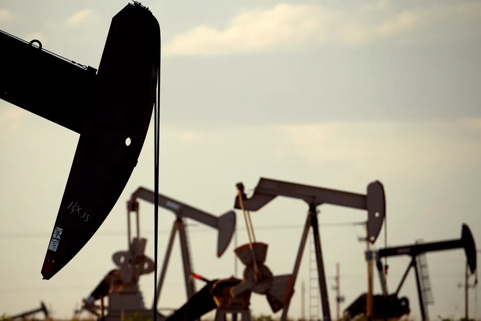 Back to work: pumpjacks work in a Permian basin field near Lovington, New Mexico