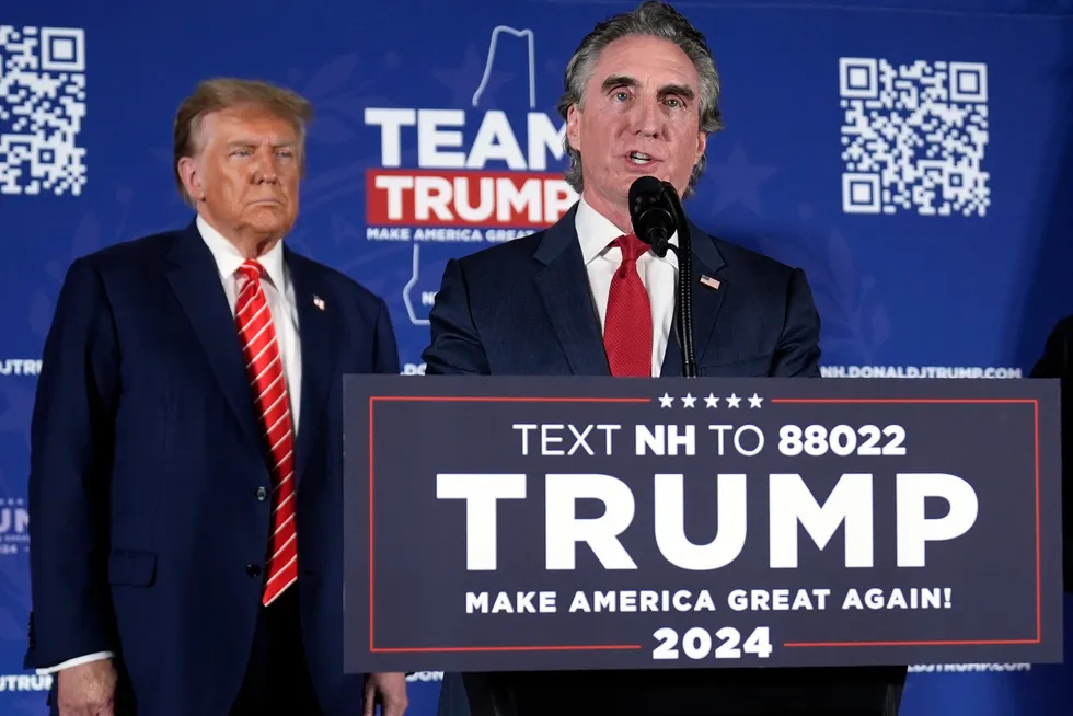 In this file photo, US President, Donald Trump, (left) while campaigning for office, listens as former North Dakota Governor, Doug Burgum (right), speaks on stage during a campaign event in Laconia, New Hampshire, on 22 January 2024.