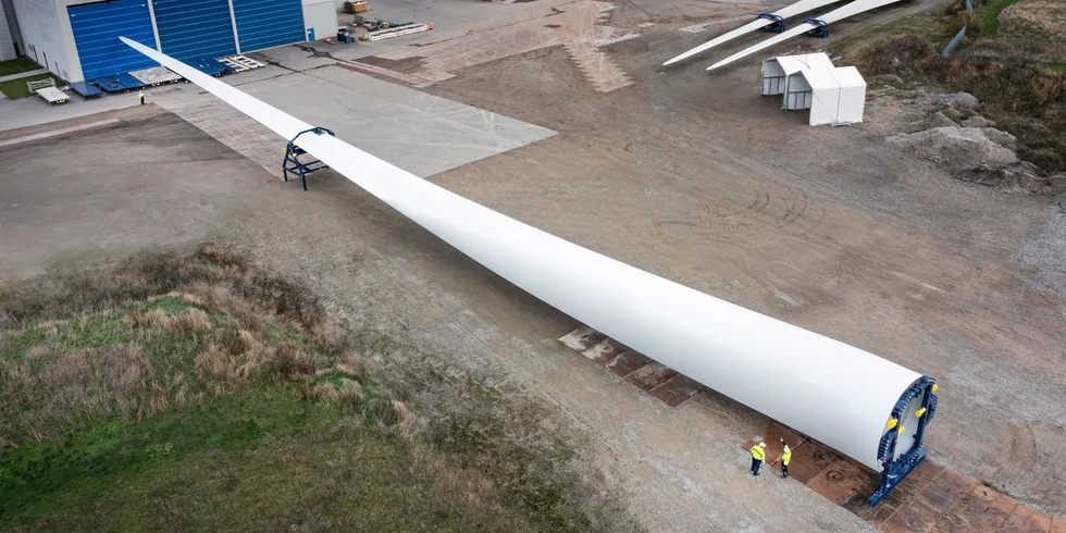 Vestas employees perform final checks on newly completed 15MW V236 wind turbine blade at factory in Nakskov, Denmark.