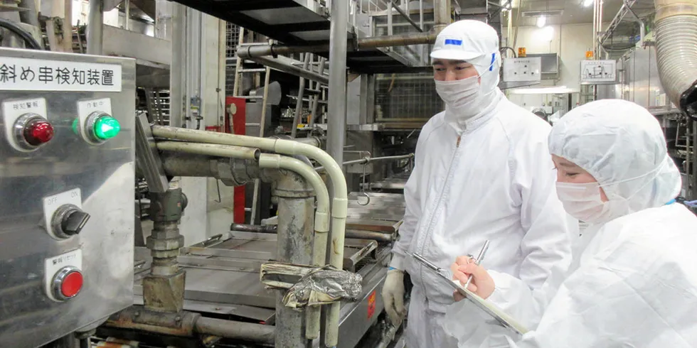Workers at a Nissui factory, where last week, a worker tested positive for COVID-19.